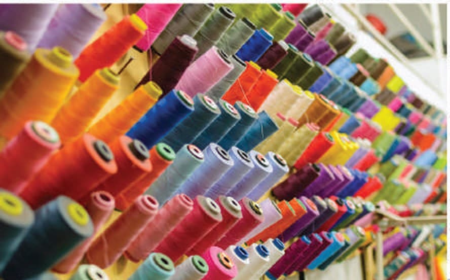 Rows of yarn spools on a textile spinning line served by process-air blowers